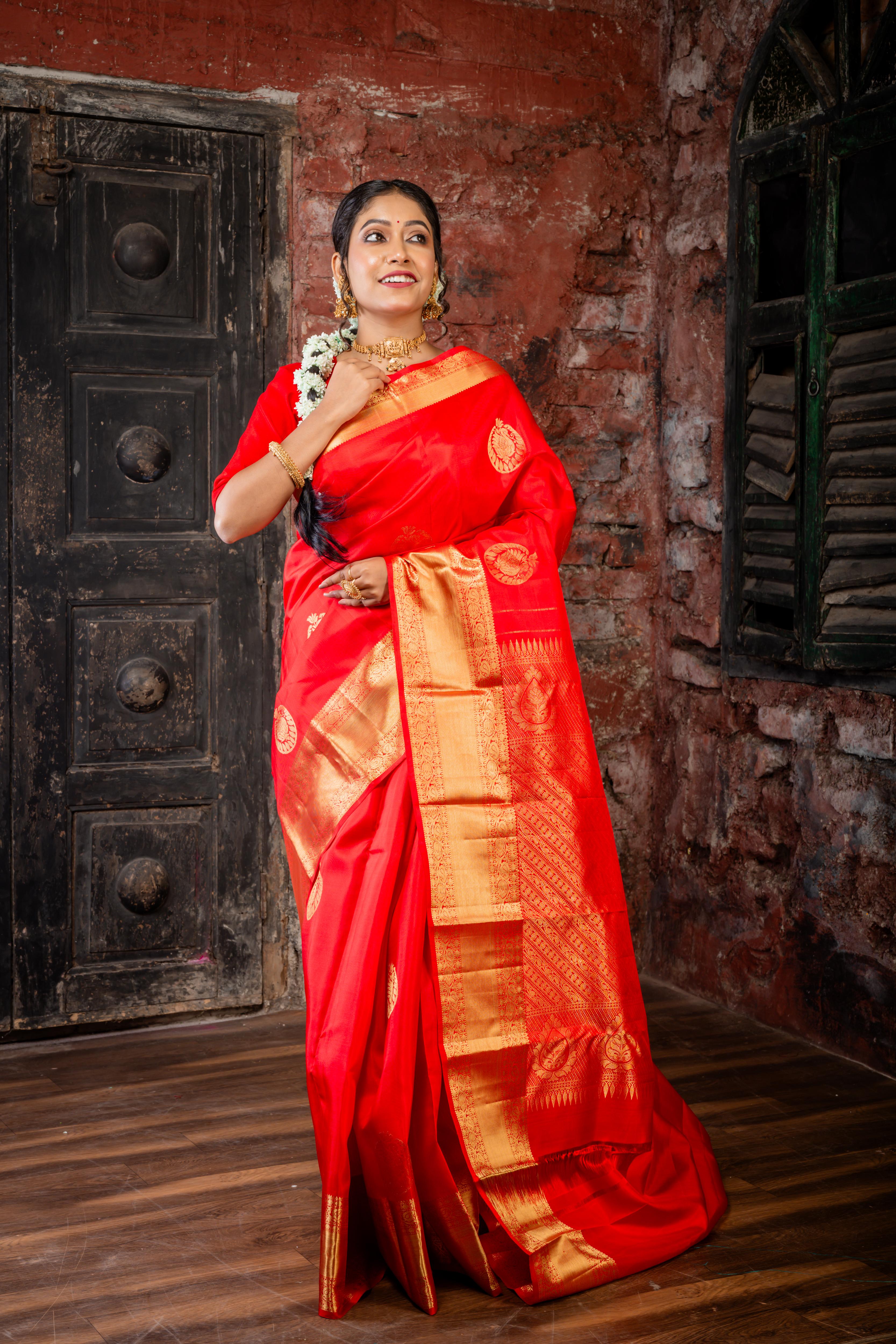 Navya || Bright Red Pure Silk Handloom Saree with all over Abharani Gold Zari Lotus & Swan motif Buta and traditional Stripe Pallu