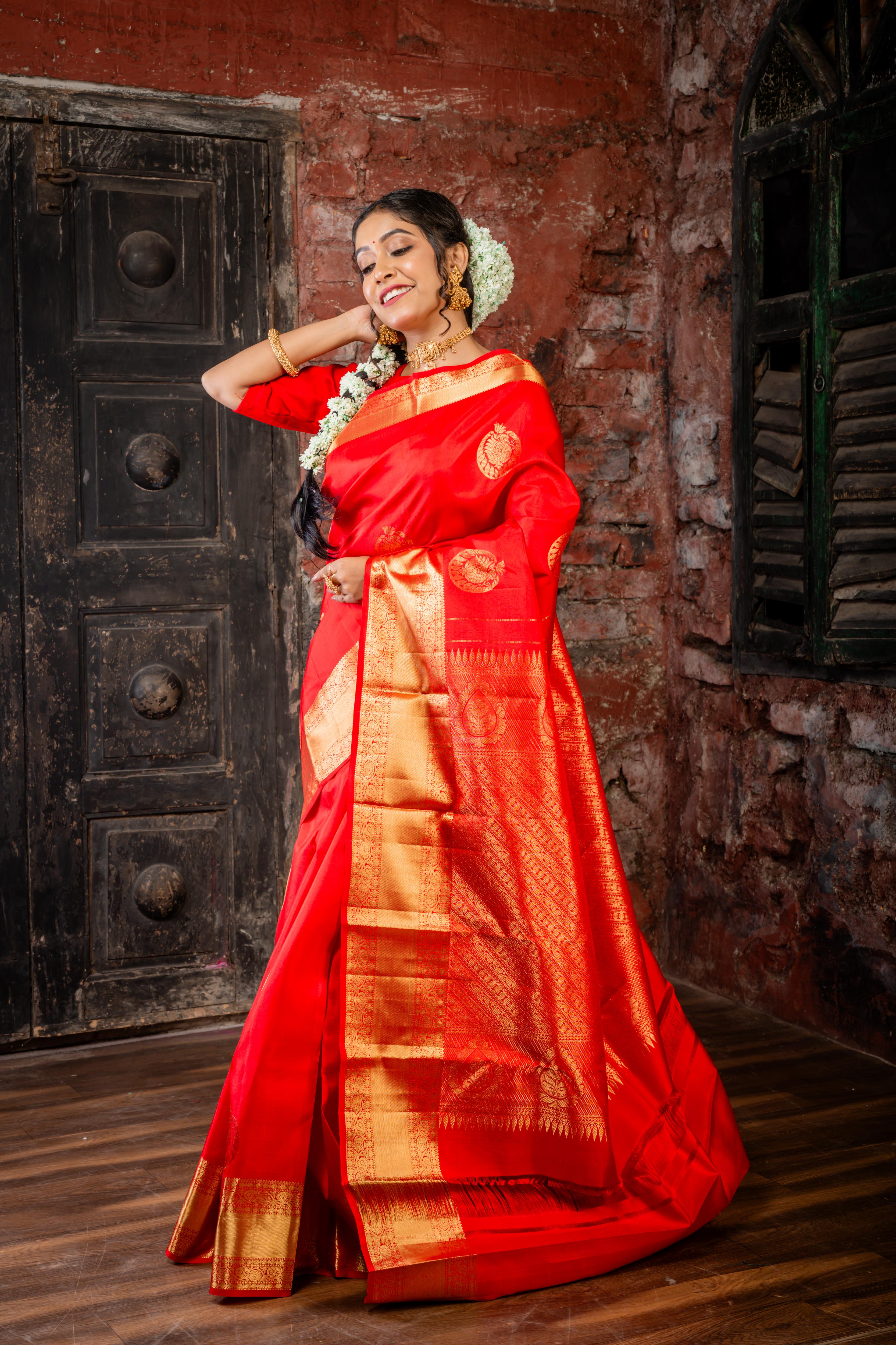 Navya || Bright Red Pure Silk Handloom Saree with all over Abharani Gold Zari Lotus & Swan motif Buta and traditional Stripe Pallu