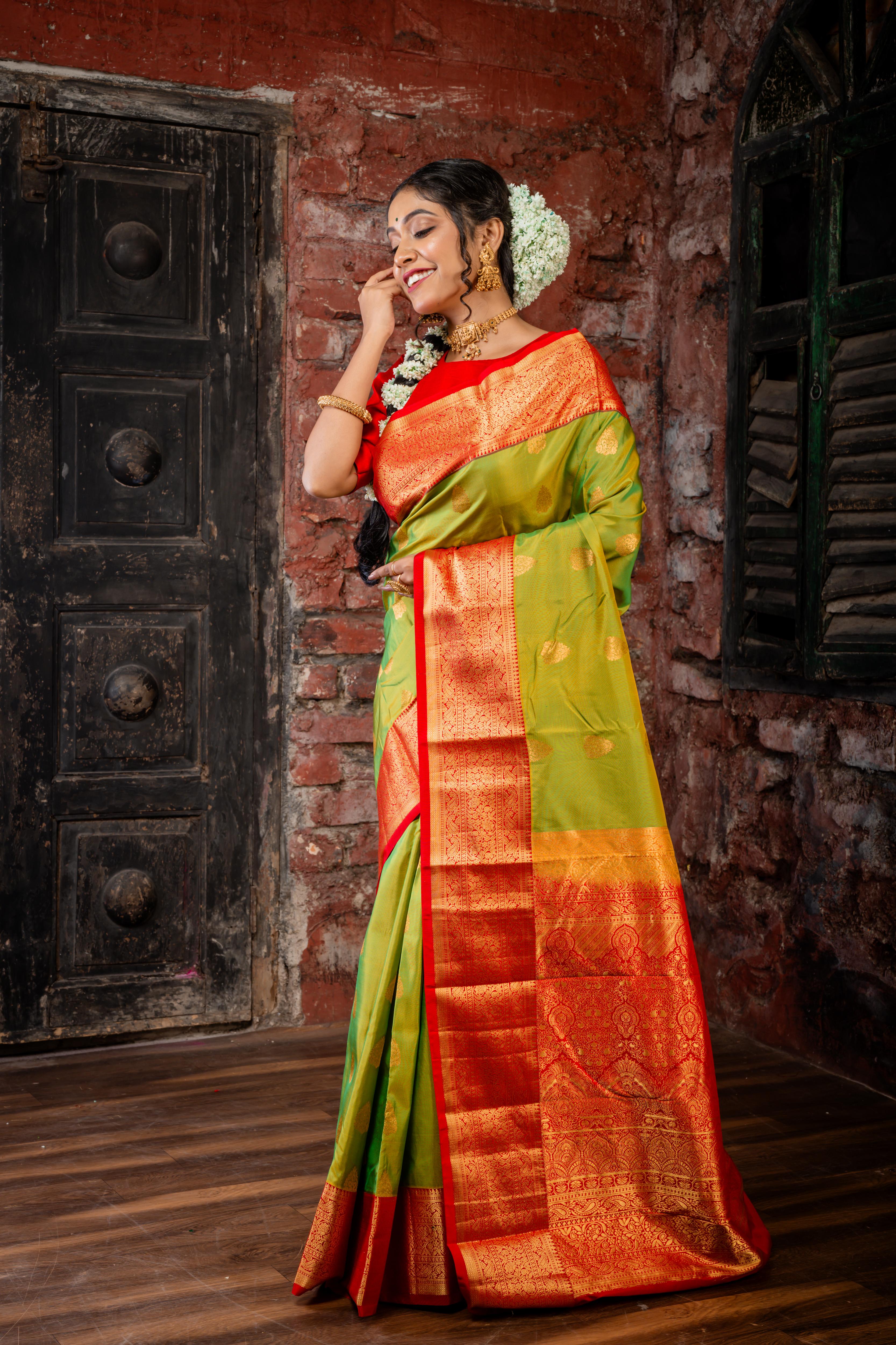 Laajvanthi || Olive Green & Mustard Yellow dual tone Pure Kanjivaram Silk Handloom Saree with all over Golden Zari traditional Buta, Red broad & Golden Zari Border and traditional design Pallu