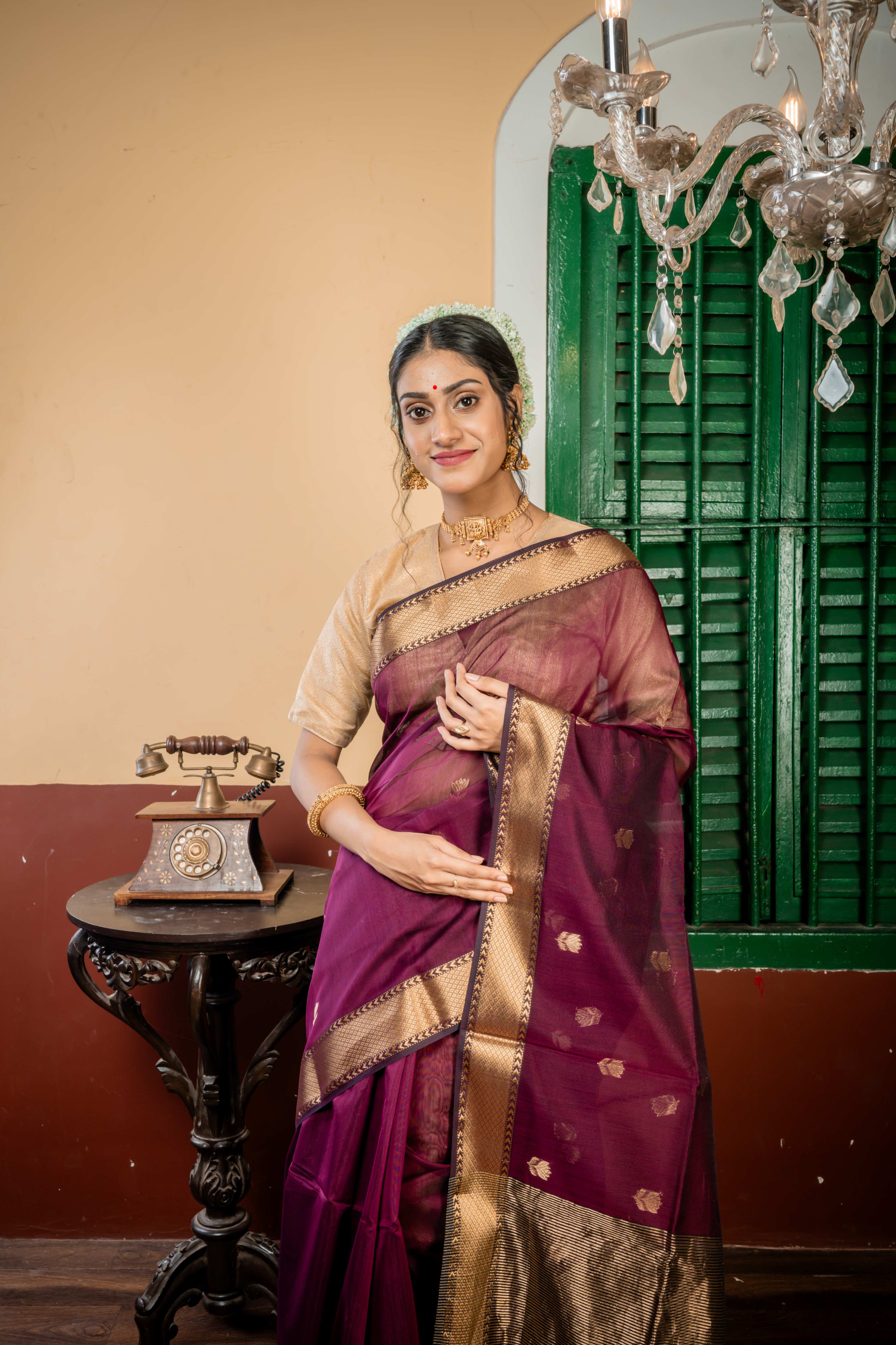 Sulochana || Wine Cotton Resham Maheshwari Handloom Saree with all over Antique Gold Zari Floral motif Buta, Black & Antique Gold Zari Brocade Border and Black & Antique Gold Stripe Pallu