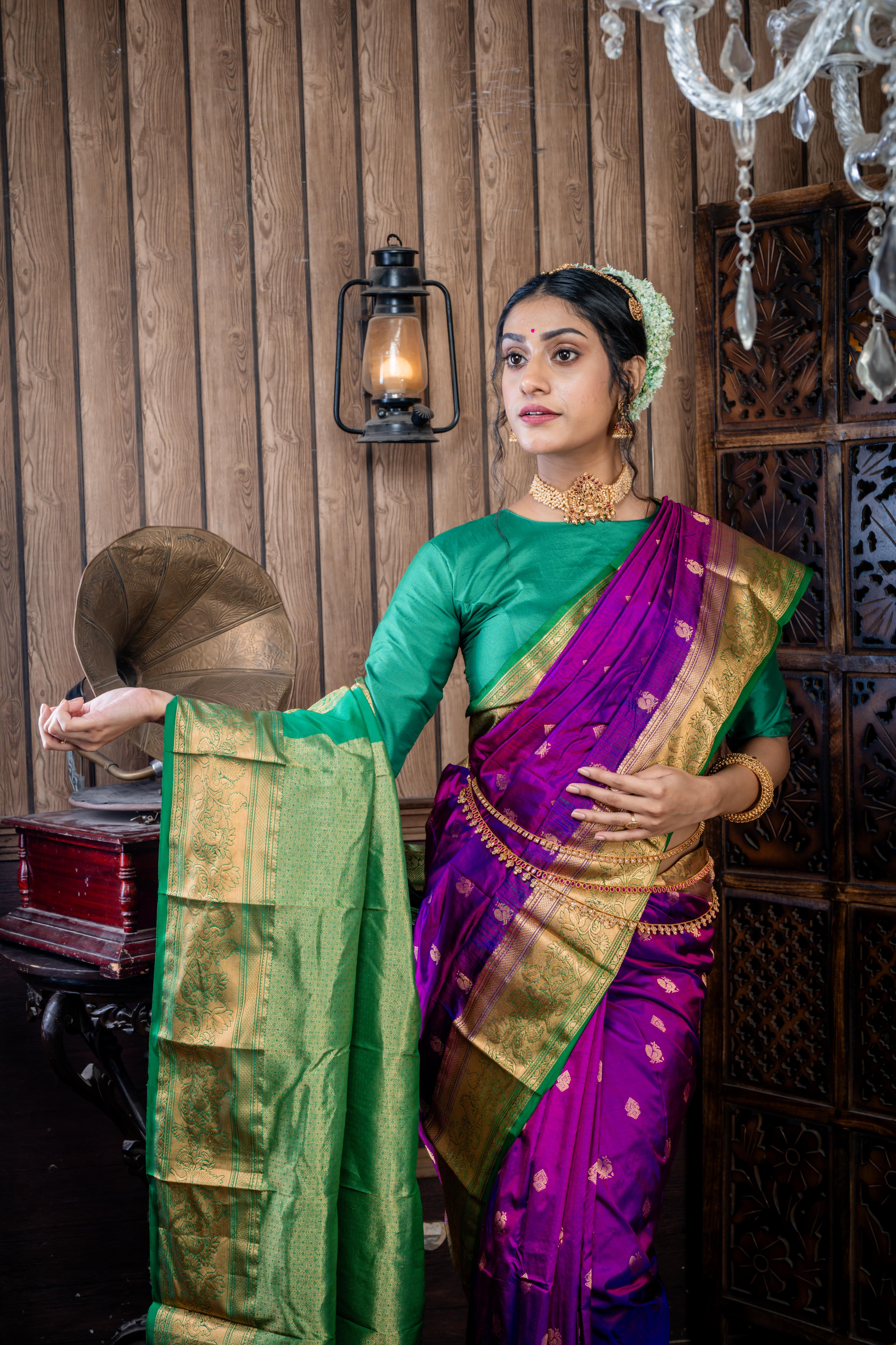 Maitri || Purple & Violet dual tone Pure Kanjivaram Silk Handloom Saree with all over Golden Zari 'Peacock' motif Buta, Dark Green broad & Golden Zari Border and traditional design Pallu