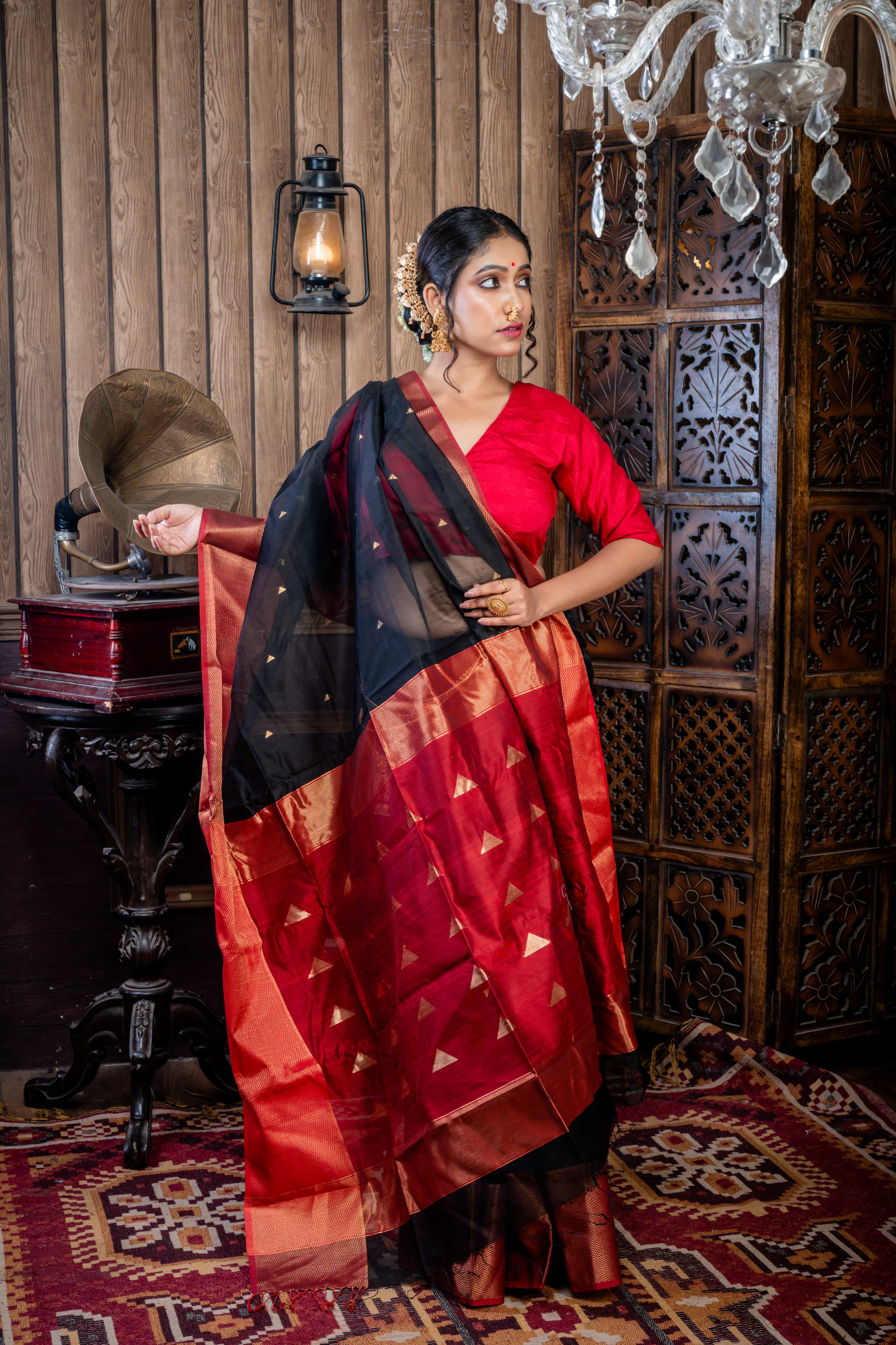 Nishita || Black Cotton Resham Maheshwari Handloom Saree with all over Antique Gold Zari Buta, Dark Garnet Red & Antique Gold Zari Brocade Border and Dark Garnet Red Pallu with Antique Gold Zari Stripe & Copper Buta
