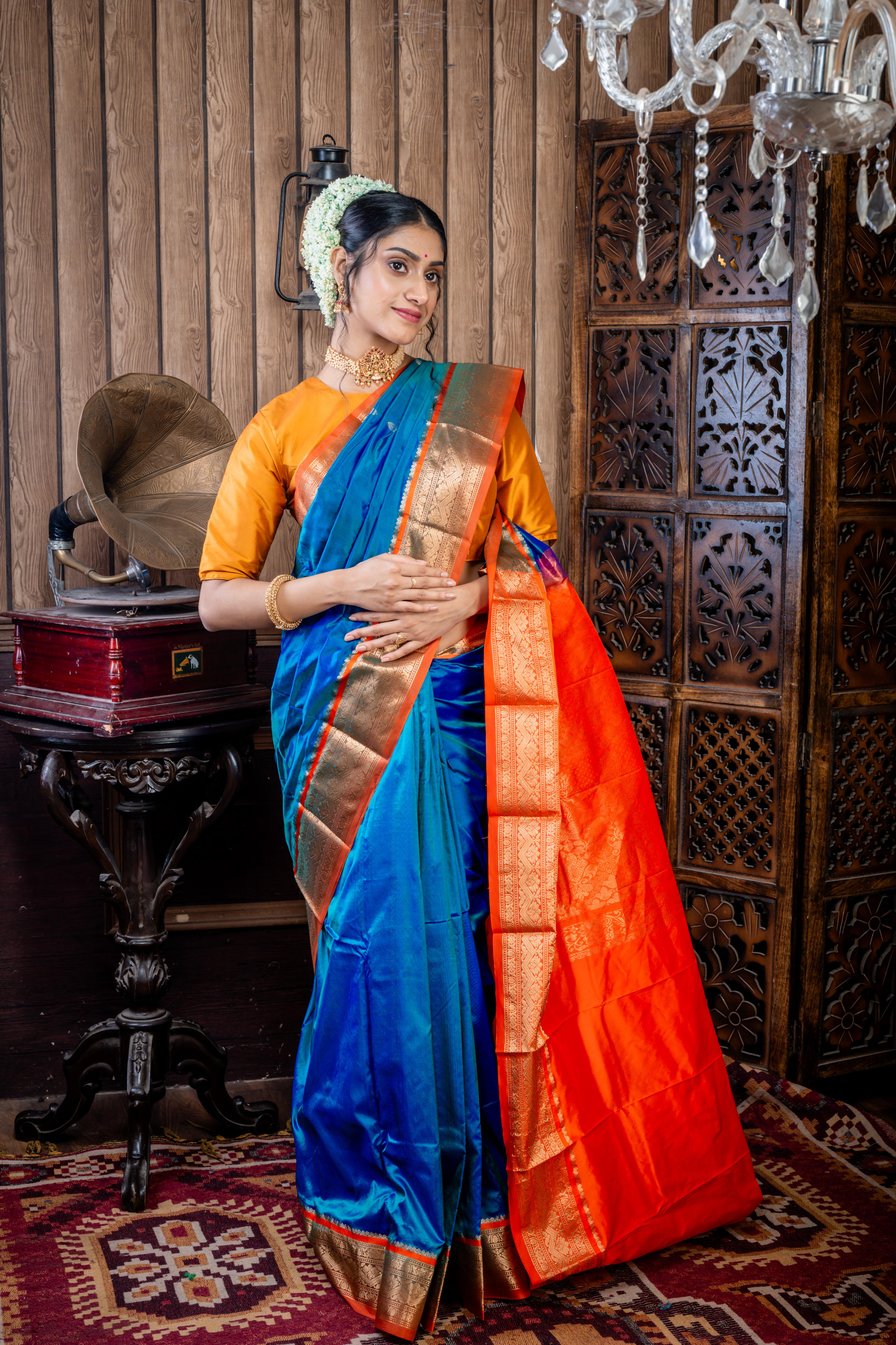 Kruttika || Peacock Blue & Green dual tone Kanjivaram Silk Saree with all over Matte Gold Zari Buta and Burnt Orange & Matte Gold Zari Traditional design Border & Pallu