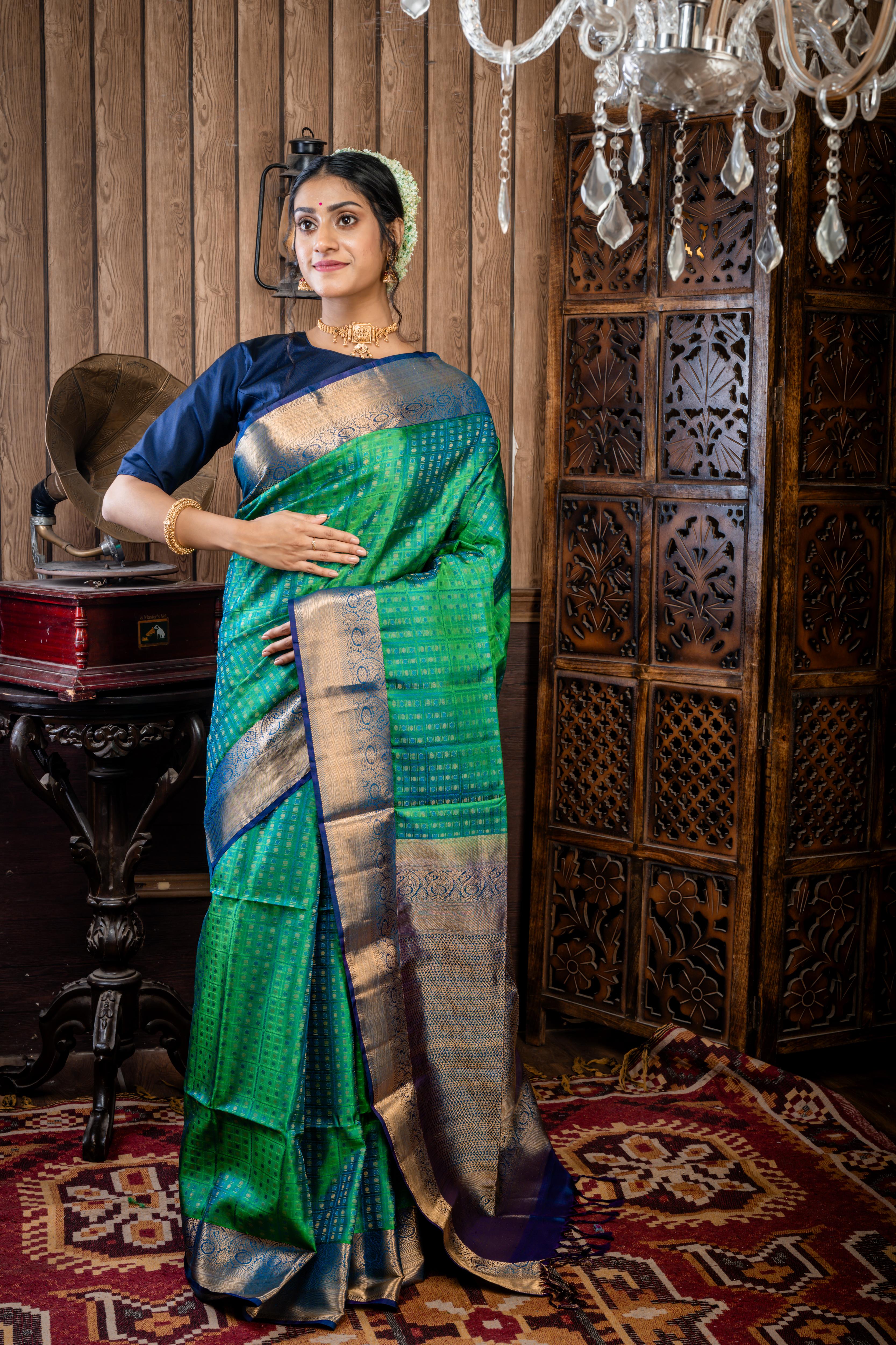 Shruthi || Leaf Green & Peacock Blue dual tone Pattu Soft Silk Handloom Saree with all over Antique Gold Zari, Peacock Blue Resham & Leaf Green Resham Buta & Checks and Violet & Peacock blue dual-tone with Antique Gold Zari Traditional Border & Pallu