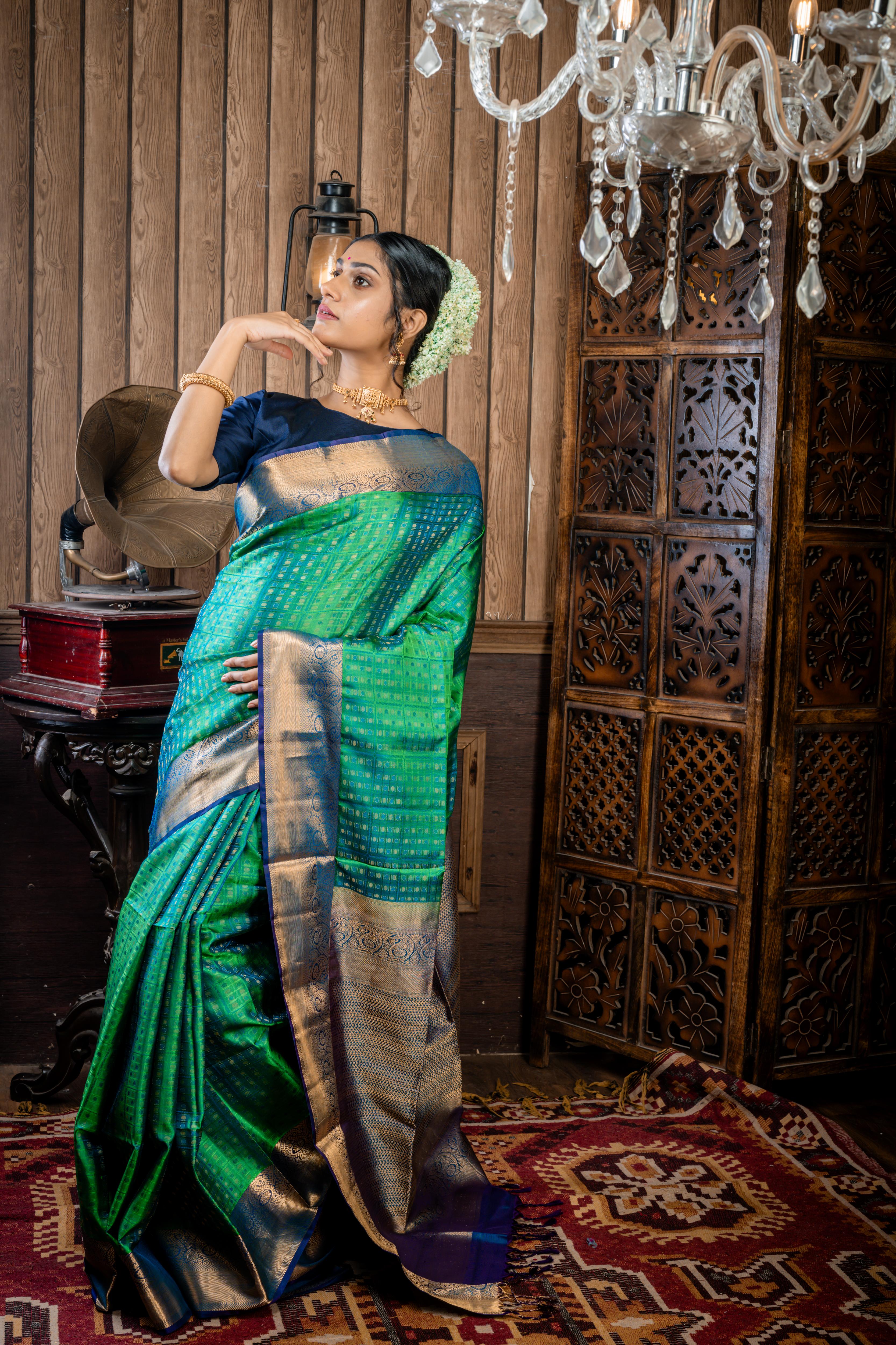 Shruthi || Leaf Green & Peacock Blue dual tone Pattu Soft Silk Handloom Saree with all over Antique Gold Zari, Peacock Blue Resham & Leaf Green Resham Buta & Checks and Violet & Peacock blue dual-tone with Antique Gold Zari Traditional Border & Pallu